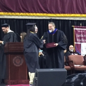 7Danville graduate Page Butler accepts her diploma from Dr. Kraska, Chair, 12-16