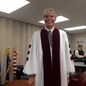 Regional Campus CJ Corrdinator Stephen Kappeler prepares to lead students into the CJS Commencement ceremony 5-16-15